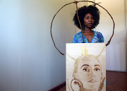 Mel Madiba (24) is seen next to her portraits that she draws in order to get some income.