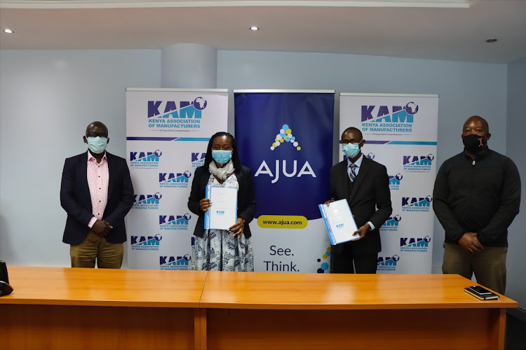 KAM Head of Membership and Governance, Tobias Alando, KAM CEO Phyllis Wakiaga, Ajua Executive VP, Gilbert Saggia and Ajua Chief Product Officer Louis Majanja presiding over the KAM-Ajua partnership agreement signing ceremony.