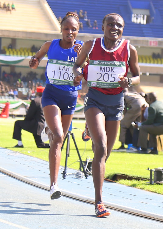 Joyciline Jepkosgei leads Hellen Obiri in 5000m race during the 40th KDF championships at Moi Stadium, Kasarani yesterday.