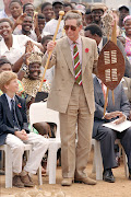 Prince Harry watches as his father is gifted with a shield and knobkerrie during a visit to a village in Dukuduku, KwaZulu-Natal in 1997.