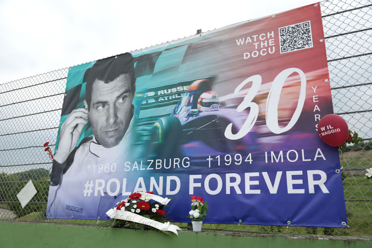 Tributes to Roland Ratzenberger hang from the catch fence during an event to commemorate the 30th anniversary of Ayrton Senna’s death at Autodromo Enzo e Dino Ferrari on May 1 2024 in Imola, Italy. Picture: GETTY IMAGES/EMMANUELE CIANCAGLINI.