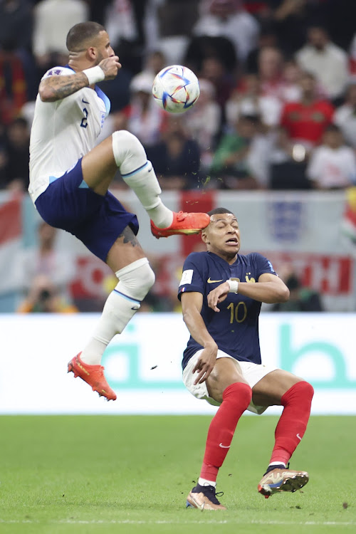 England's Kyle Walker (L) vies for the ball with Kylian Mbappe of France during the 2022 Fifa World Cup at Al Bayt Stadium in Al Khor, Qatar, on December 10