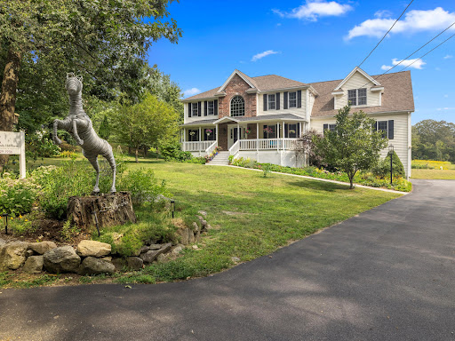 Buy this luxury property in Upton (United States) - Large white house with porch and garden