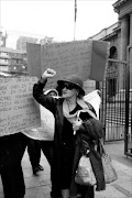 FACING THE LAW: Lynnette van Rooyen is accosted by angry staff members outside the Johannesburg high court. Pic. MOHAU MOFOKENG. 29/06/2010. © Sowetan.