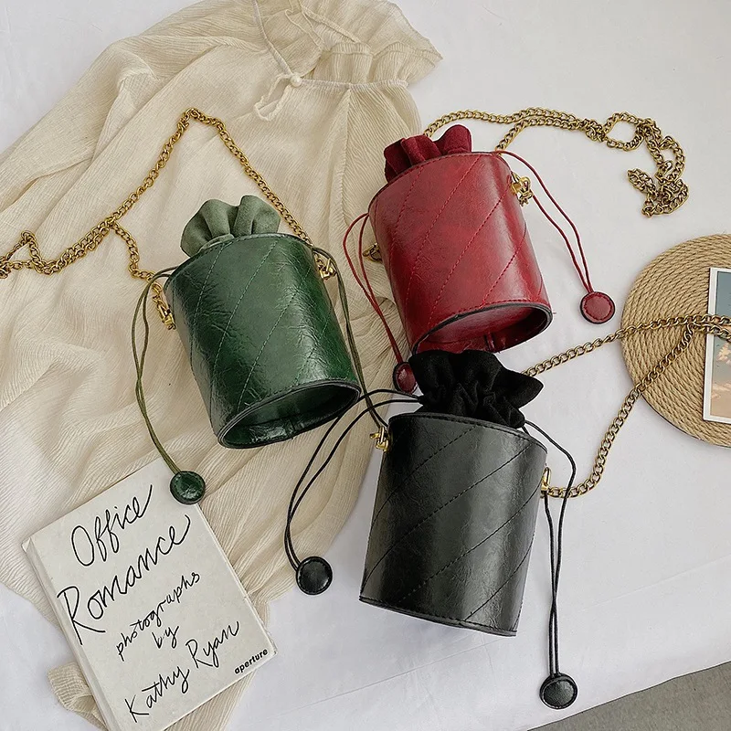 Chain Drawstring Bucket Bag Carry your essentials in style with this chic and versatile bucket bag, featuring a secure d
