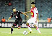 BALL WIZARDS: Thandani Ntshumayelo of Orlando Pirates tries to dispossess Ajax Cape Town's Scott Granwald during last night's Absa Premiership match at Orlando Stadium in Soweto Picture: