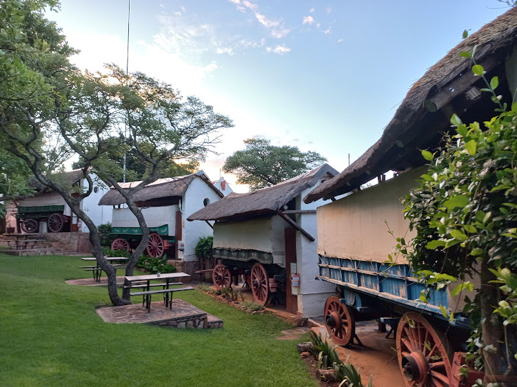 The half-moon laager of six wagons at the Oxwagon Lodge, overlooking a spacious garden and large, covered dining area. Picture: LUCILLE DAVIE