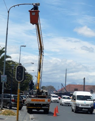 A contractor repairs street lights in Cape Town. File photo.