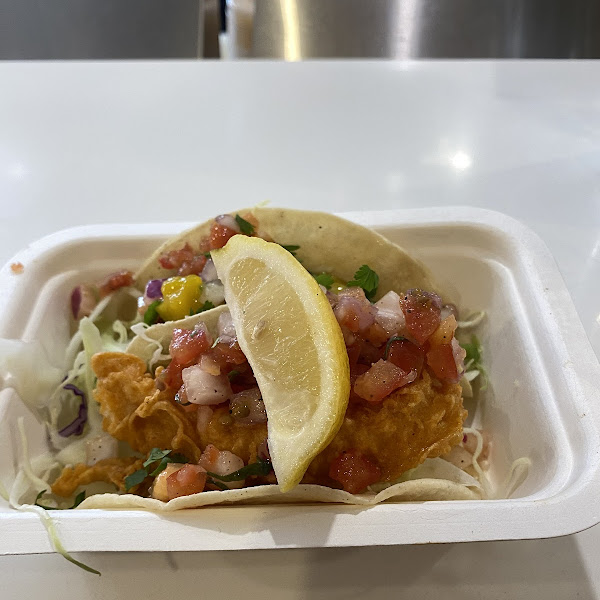Battered fish taco in front!