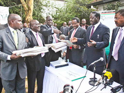 Lawyer Anthony Oluoch and Committee of Experts chairman Paul Mwangi handover Okoa Kenya booklets with 1.6 million referendum signatures to Cord leaders Kalonzo Musyoka, Raila Odinga and Moses Wetang’ula in Nairobi. Photo/ COLLINS KWEYU