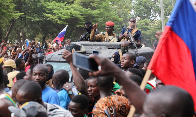 Burkina Faso's self-declared leader Ibrahim Traore is welcomed by supporters holding Russian flags as he arrives at the national television in an armoured vehicle in Ouagadougou on October 2 2022. File image