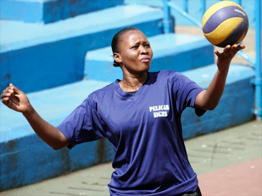 Rahab Muthoni of Kenya Deaf Volleyball team serves during training session at Nyayo National Stadium volleyball courts on March 19, 2016.They are preparing for the Africa Deaf Games to be held in April in Nairobi. Photo/Mohammed Amin. (AADG)