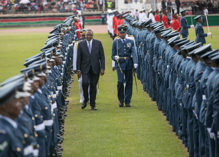 President Uhuru Kenyatta inspects a guard of honour mounted by the Kenya Defence Forces at the Nyayo National Stadium in Nairobi for the 2019 Jamhuri Day Celebrations.