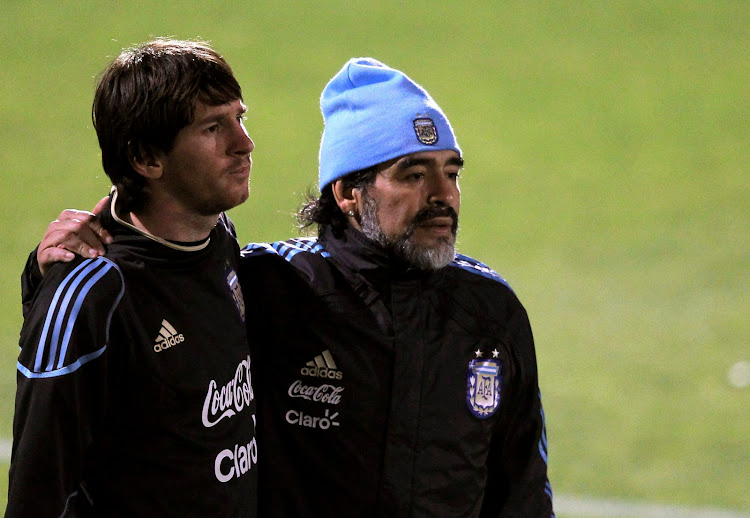 Argentina's coach Maradona walks alongside Messi after a practice session in Pretoria