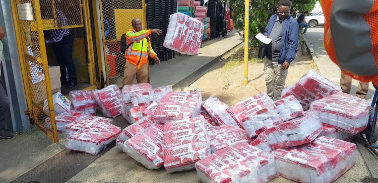 Law enforcement officials at China Town Mall in North End, East London, where goods ranging from light bulbs, toilet paper, blankets and other goods were confiscated yesterday.