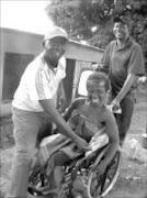 JOYOUS MOBILITY: Matsie Malatji, in the wheelchair, with community development worker Strawberry Makgoba, and councillor Masilu Maloko from the Greater Tzaneen municipality. Pic. Alex Matlala. 16/10/07. © Sowetan.