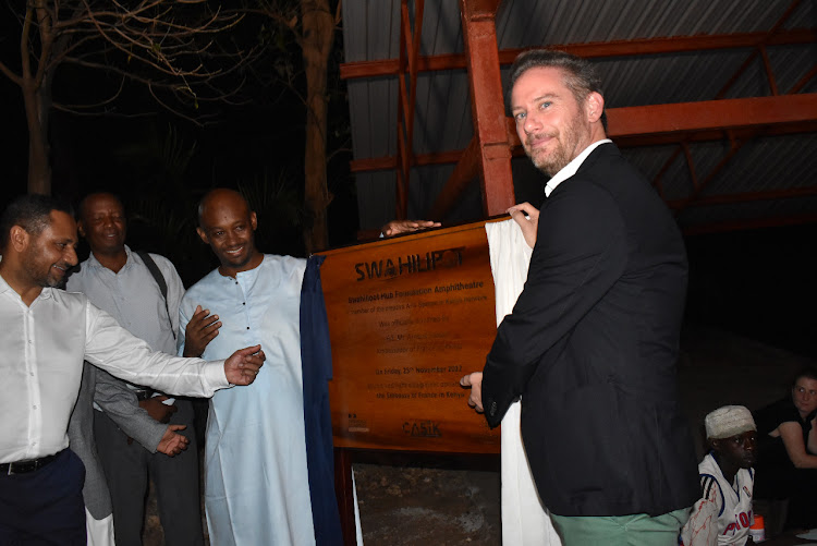 French ambassador Arnaud Suquet accompanied by Swahili Pot founder and editorial director Mhamud Noor unveil the plaque during the launch of Swahili Port