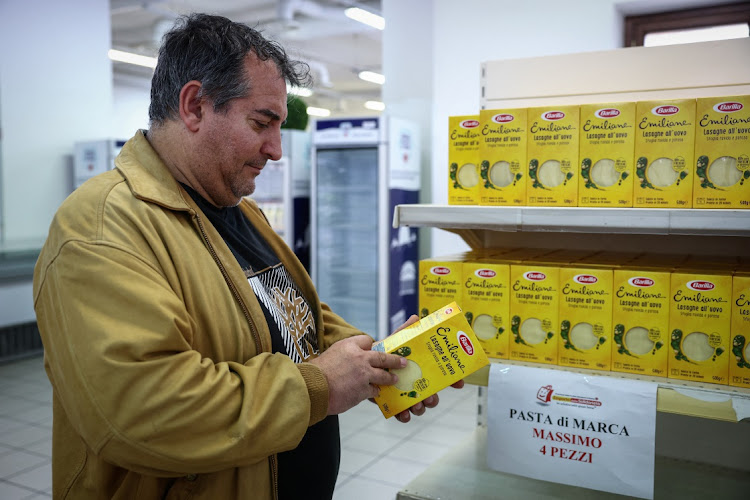 Luigi, who before losing his job was a builder and owner of a video surveillance system company, shops at Caritas Emporium, a supermarket financed with money collected from the Trevi Fountain. Picture: REUTERS/GUGLIELMO MANGIAPANE