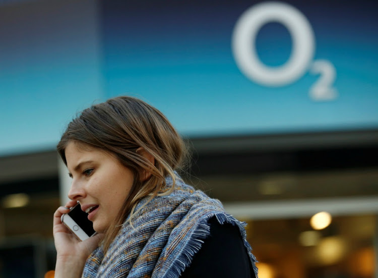 A woman speaks on a mobile telephone outside an O2 store in central London in this November 24, 2014 file photo. Picture; REUTERS/LUKE MACGREGOR