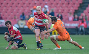 Tomas Lavanini of the Jaguares (L) tackles Ross Cronje of the Emirates Lions with Pablo Matera(c) of the Jaguares(R) during the 2018 Super Rugby game between the Emirates Lions and the Jaguares at Emirates Airline Park Stadium, Johannesburg on 21 July 2018. 
