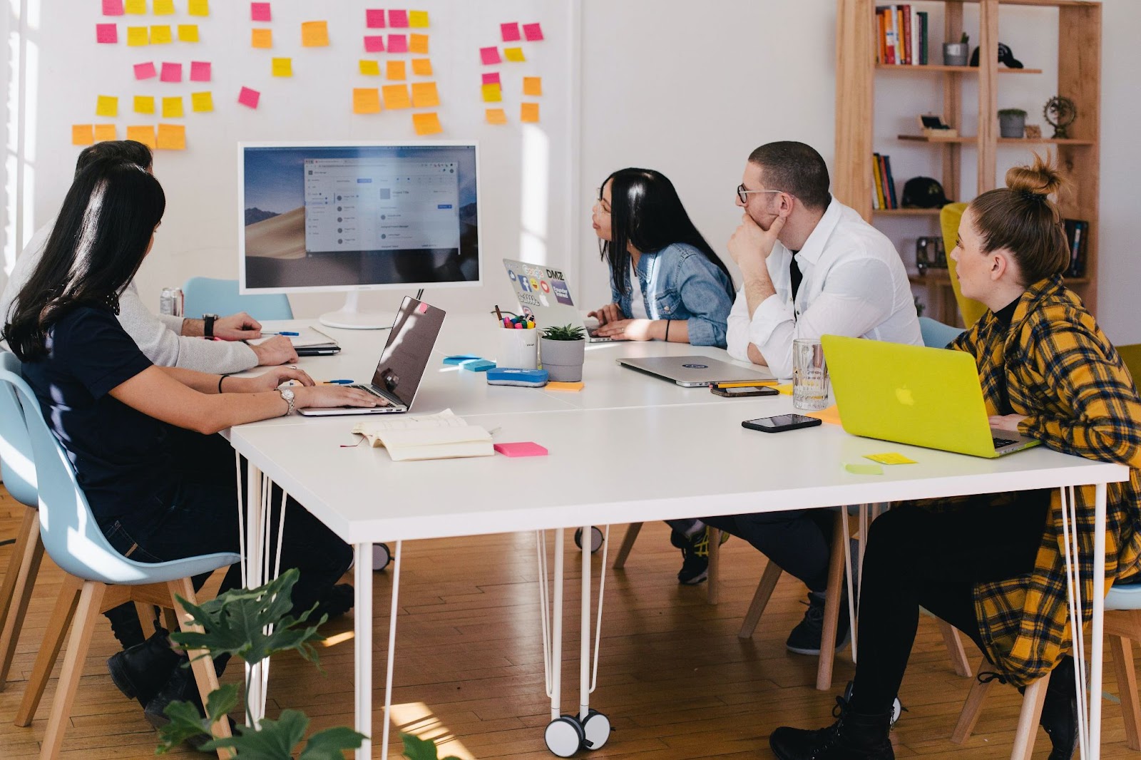 Colleagues in a meeting with interactive display