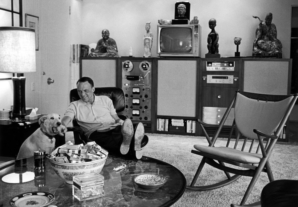 Frank Sinatra relaxing with pet dog Ringo at home, 1965.