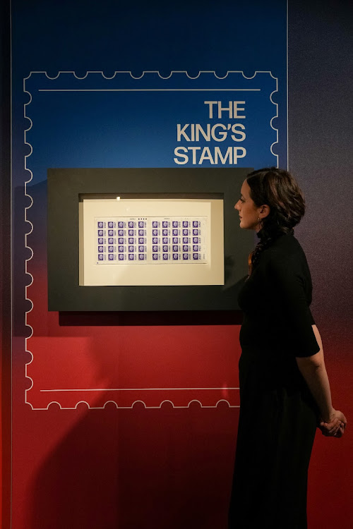 A Postal Museum employee looks at the new definitive stamps depicting Britain's King Charles, unveiled by the Royal Mail, in London, Britain February 7, 2023.