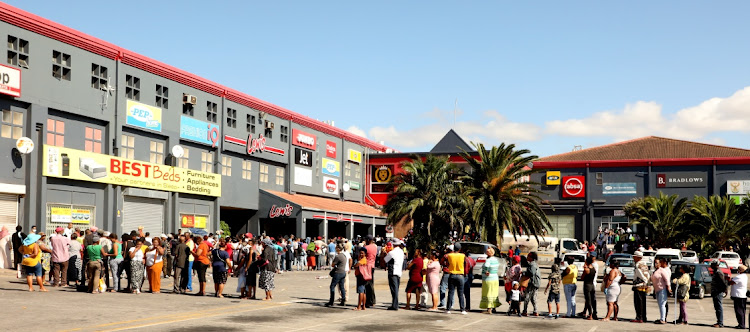 WALKING THE LINE: People queue outside the Cleary Park shopping centre to get their Sassa grants