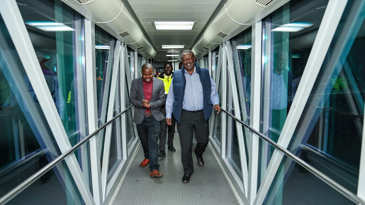 Prime Cabinet Secretary Musalia Mudavadi with his deputy Director for Press Service Anders Ihachi when he arrived at Jomo Kenyatta International Airport from The United Kingdom on Thursday.