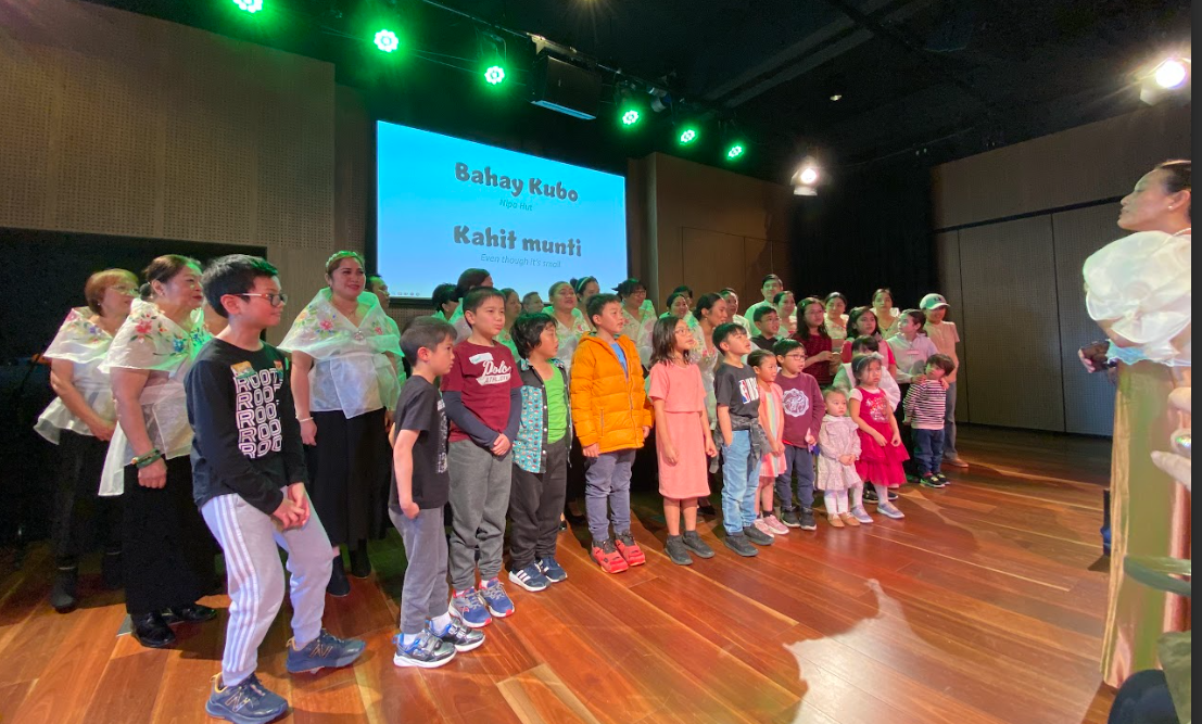 A group of children standing in a lineDescription automatically generated