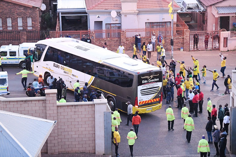 Al Ahly SC bus with Pitso Mosimane and Al Ahly SC players pass the Mamelodi Sundown fans singing and chanting outside Lucas Moripe Stadium after the CAF Champions League Quarter Final, 2nd Leg match between Mamelodi Sundowns and Al Ahly SC at Lucas Moripe Stadium on May 22, 2021 in Pretoria, South Africa.