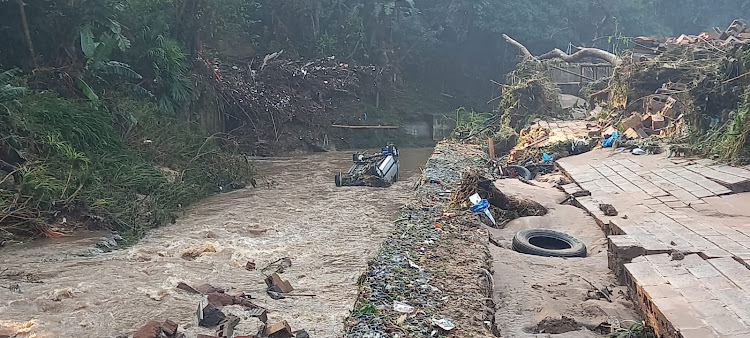 A vehicle was swept into a river near Pinetown, west of Durban, in the heavy rain.