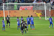 Thabiso Kutumela of Orlando Pirates scores a goal while goalkeeper Richard Ofori looks on during the Absa Premiership match between Orlando Pirates and Maritzburg United at Orlando Stadium on February 03, 2018 in Johannesburg.