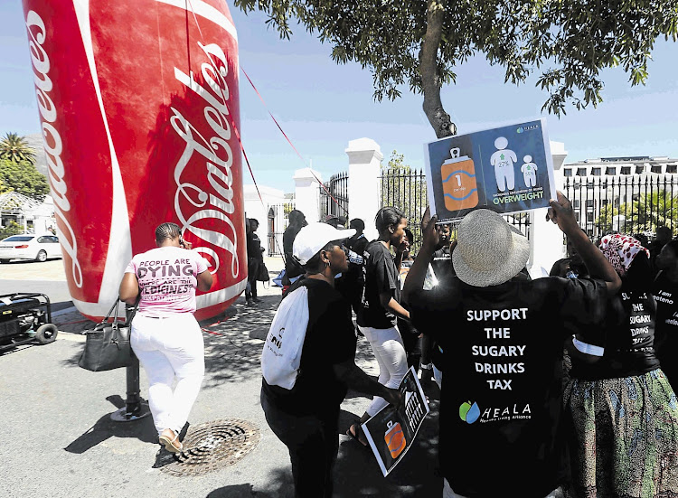 Protesters gather outside parliament in Cape Town where the first round of oral submissions was held yesterday as part of the hearings into a proposed 'sugar' tax on soft drinks, energy drinks and sweetened milk.