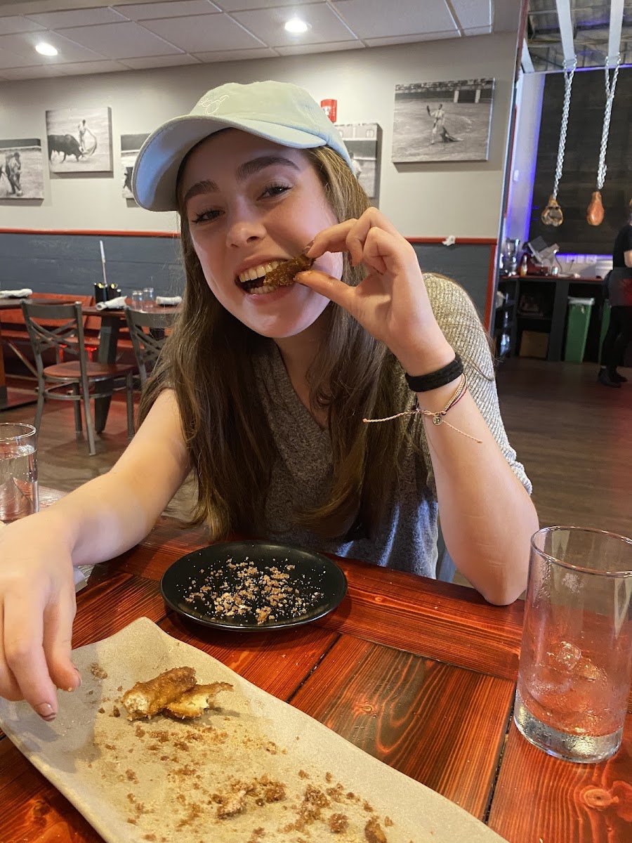 Happy celiac with an empty plate of churros