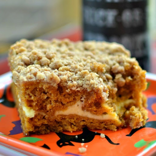 This scrumptious moist Pumpkin Cake has a lightly sweetened thin layer of cream cheese and a luscious crumb topping.  Pumpkin pie spice takes this cake over the top with the best that fall has to offer.