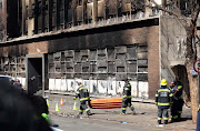 Fire fighters during the Marshalltown fire building which killed 74 people in the early hours of Thursday.