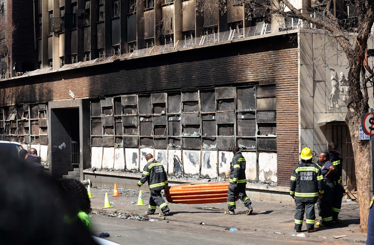 Fire fighters during the Marshalltown fire building which killed 74 people in the early hours of Thursday.
