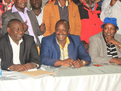 PPPK's candidate Andrew Maritim (left), Bomet governor Isaac Rutto and Kuresoi south MP Zakayo Cheruiyot follow the proceedings pensively at the Kyogong secondary school tallying center on Friday night. Photo/FELIX KIPKEMOI