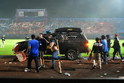 Supporters enter the field during the riot after the football match between Arema vs Persebaya at Kanjuruhan Stadium, Malang, East Java province, Indonesia, October 2, 2022.