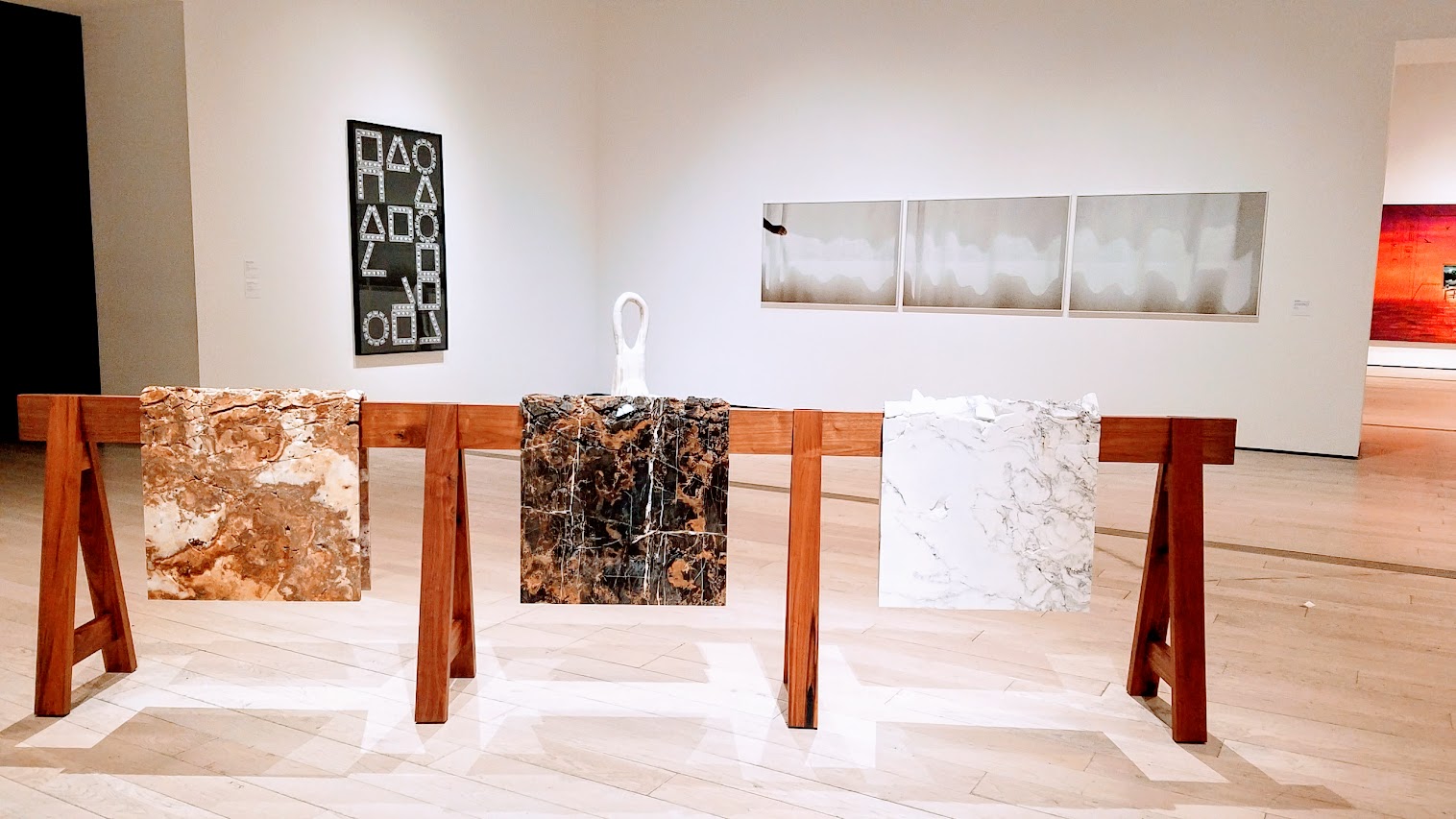 Draped Marble (Carrara, St. Laurant, Brown Onyx) by Analia Saban. Marble mounted on steel on wooden sawhorse. Displayed at Broad Contemporary Art Museum at LACMA