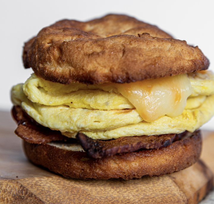 Famous "Fast Sammy" breakfast sandwich on buttermilk biscuit with eggs, bacon and cheddar.