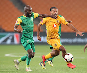 Kaizer Chiefs right-back Reeve Frosler (R) is challenged by Sandile Zuke of Lamontville Golden Arrows during the 1-1 Absa Premiership draw at the FNB Stadium in Johannesburg on April 23 2019.
