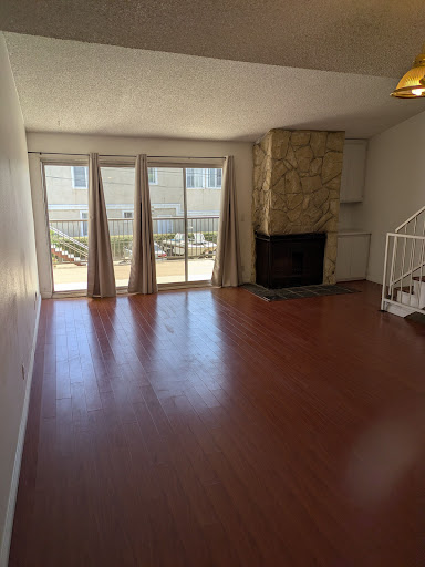 Living room with fireplace and large windows in this luxury house for rent in Redondo Beach ($4,600)