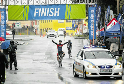 ARMS AND THE MAN: 2016 Daily Dispatch Cycle Tour champ Bradley Gouveris crosses the line last year, arms held aloft at the finish just above Buffs club. Gouveris will be back to defend his title in tomorrow's race. Picture: MARK ANDREWS