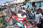 Shaun Weitz, a former gangster in Hanover Park on the Cape Flats, now fixes bicycles he supplies to children in his neighbourhood.