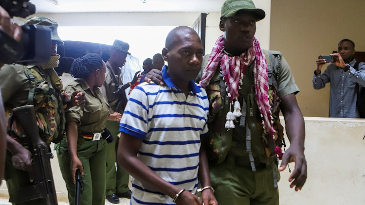 Paul Mackenzie, a Kenyan cult leader accused of ordering his followers, who were members of the Good News International Church, to starve themselves to death in Shakahola forest, is escorted to the Malindi law courts in Malindi, Kilifi, Kenya, on January 17 2024.