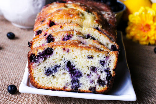 Slices of Lemon Glazed Blueberry Tea Bread.