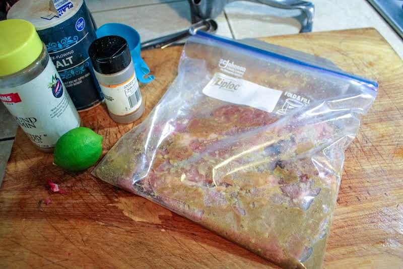 Lime Juice, Seasonings, And Beef In A Resealable Plastic Bag.