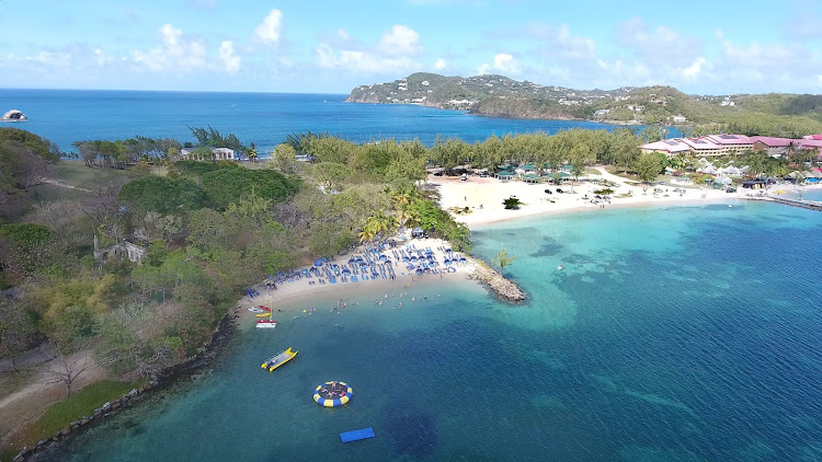 Drone shot of the blue Atlantic and turquoise Rodney Bay at Pigeon Island, a national park in the north of St. Lucia. 